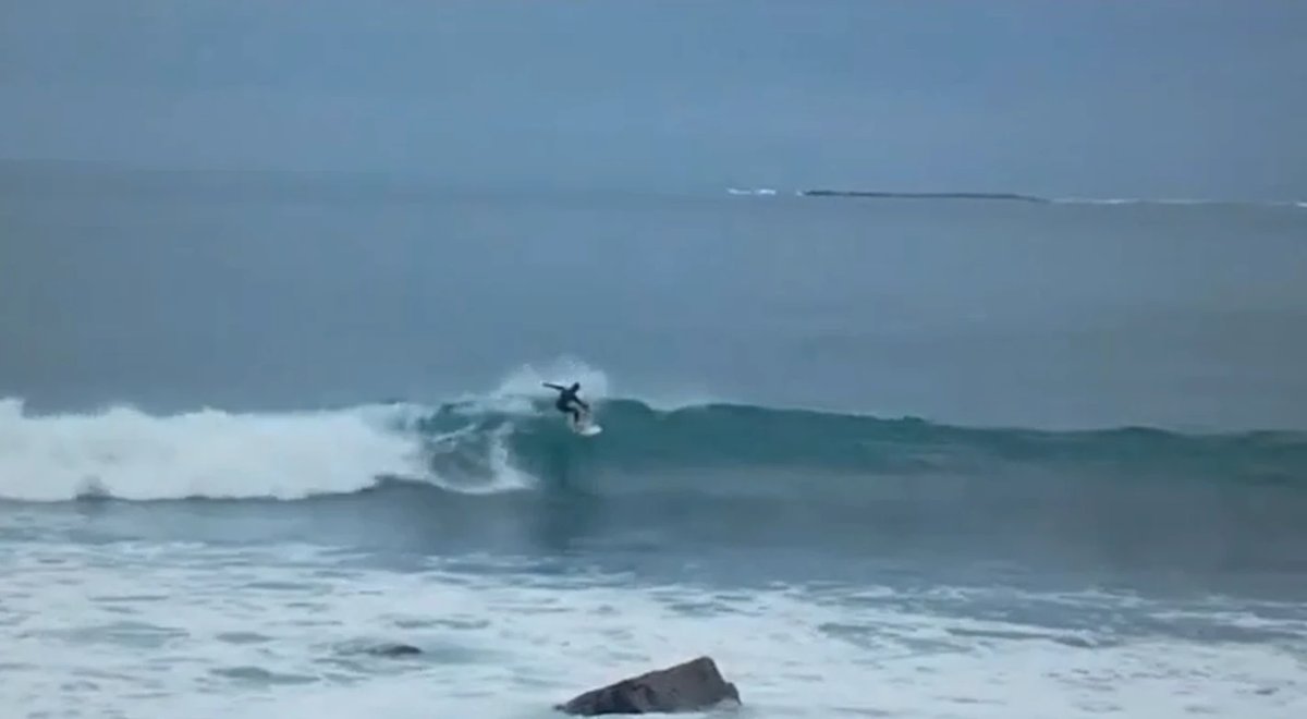 Laying into a turn on a clean grey one, the point wall running on toward the rocks, Porridge surf spot, Catlins / Southland, 